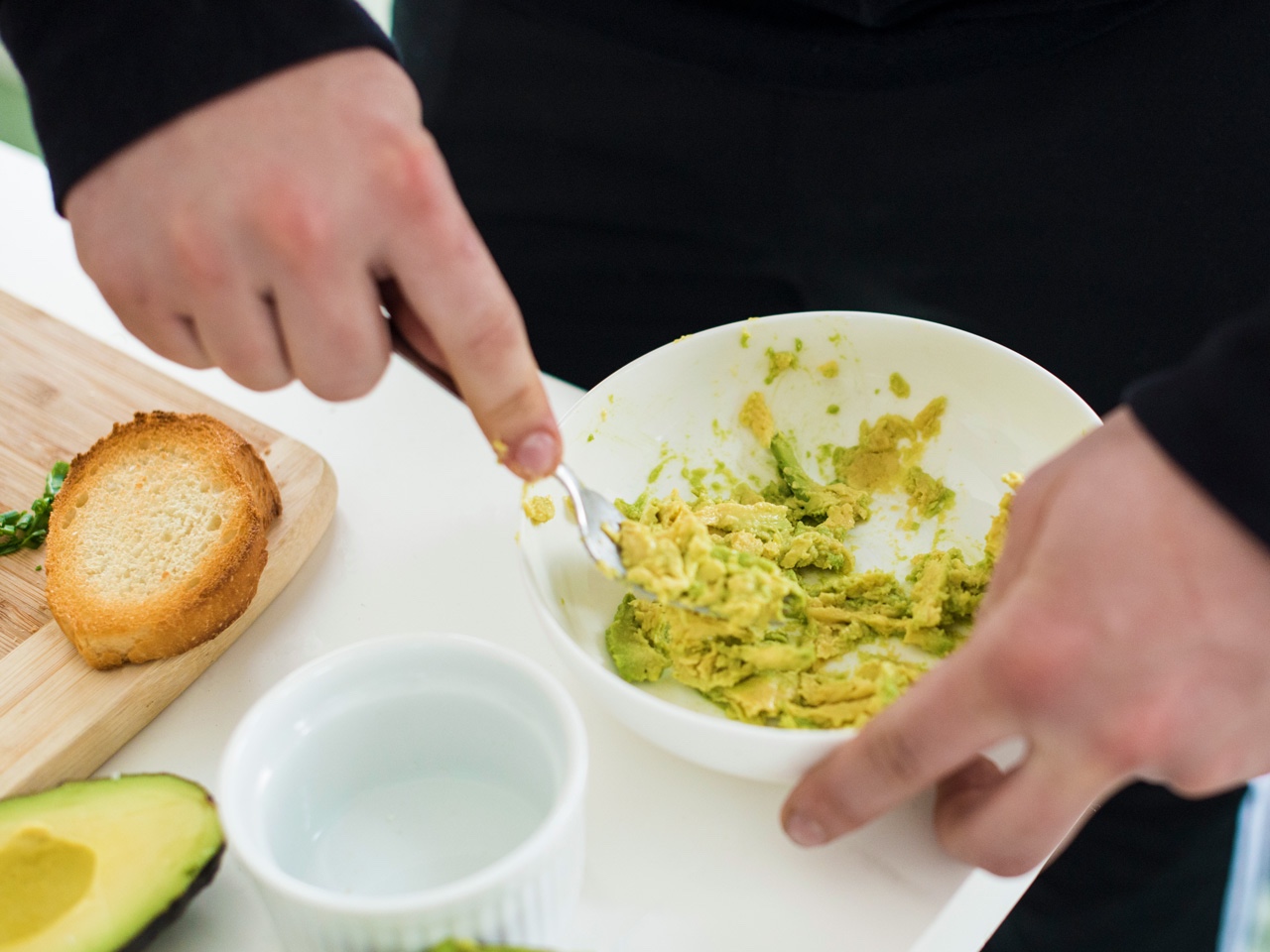 Man mashing avocado